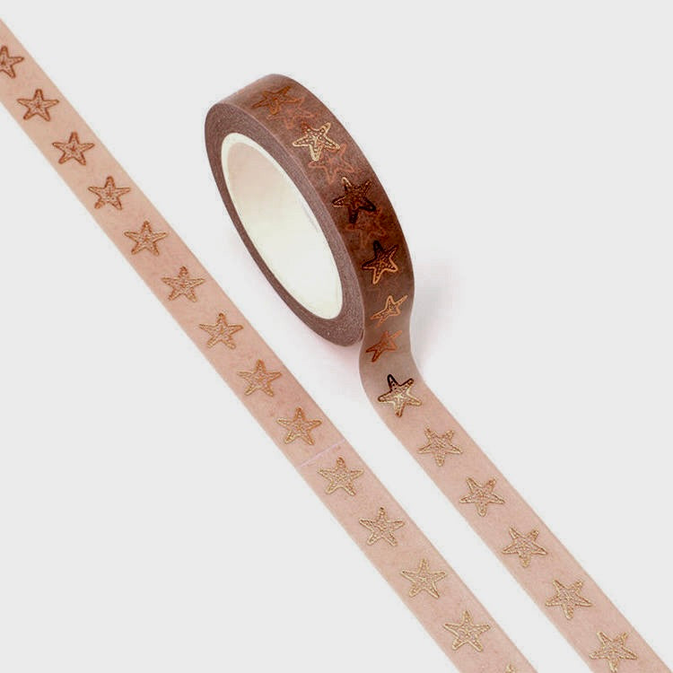 A roll of washi tape with a light beige background and metallic rose gold star fish pattern, shown partially unrolled on a light gray background.