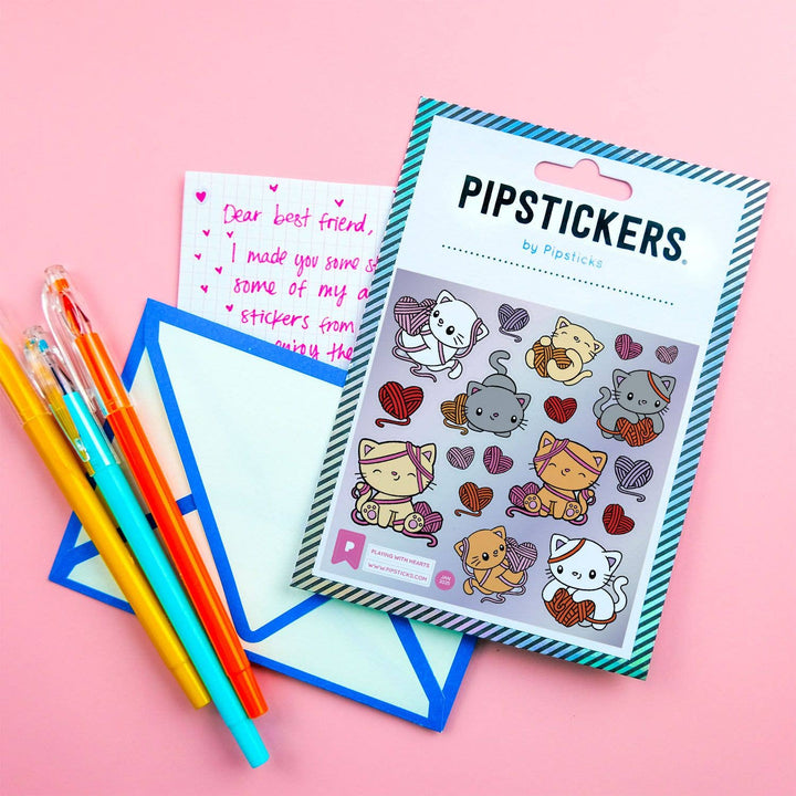 Pack of Pipsticks stickers with colorful pens and paper on a pink background