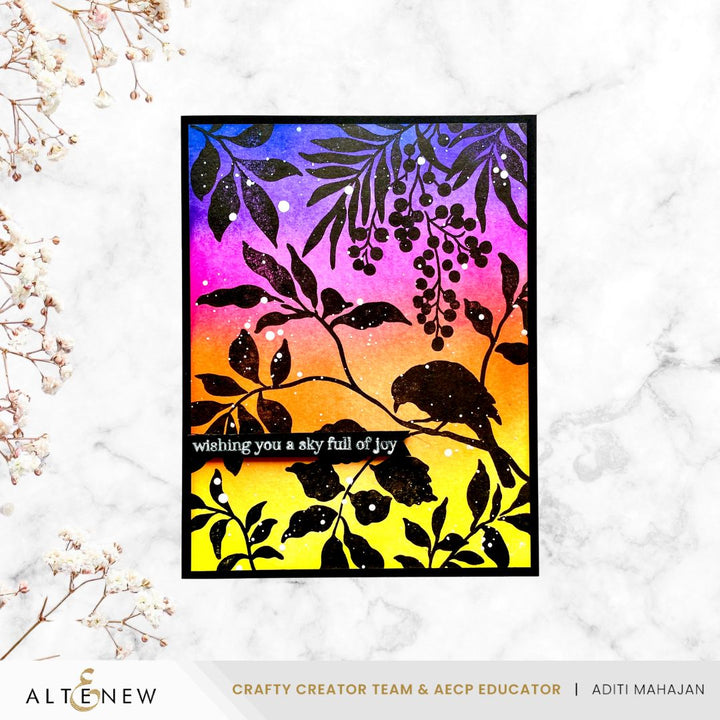 Colourful card with black leaf and bird silhoette design on a white marble background