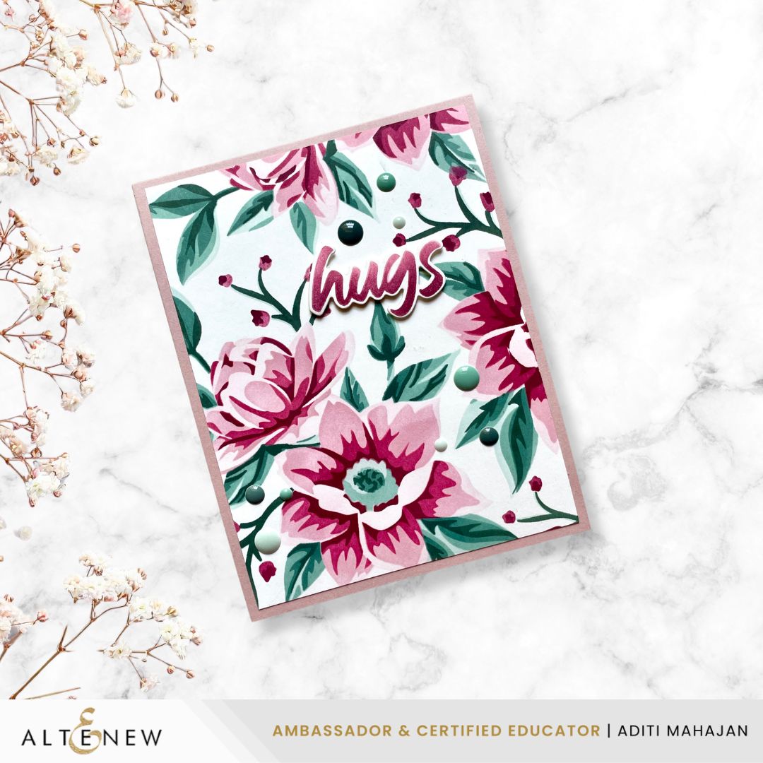 Floral card with 'hugs' text on a marble surface, featuring the brand 'Altenew'.