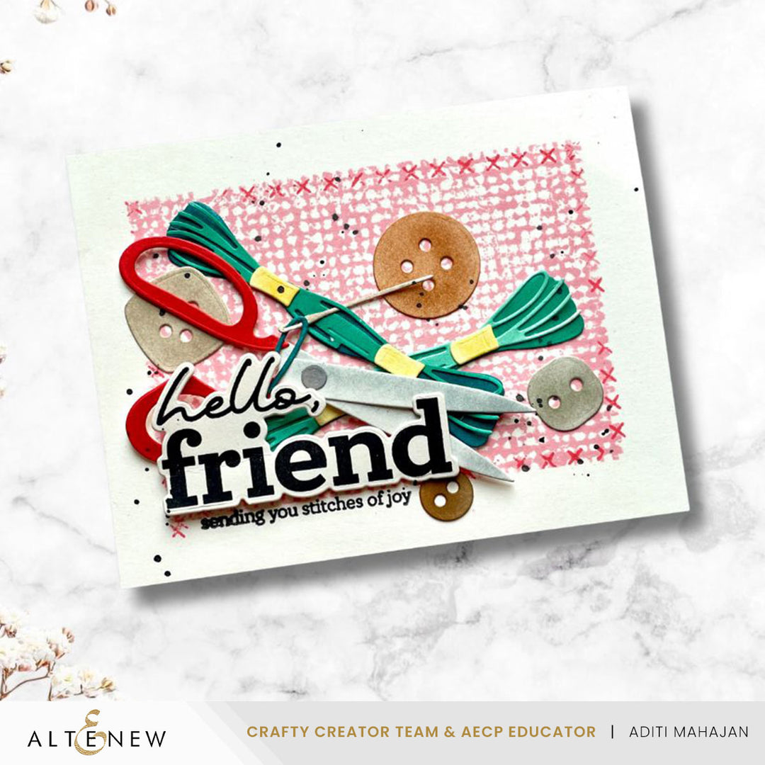 Greeting card with sewing-themed decorations and 'hello friend' text on a white marble background.