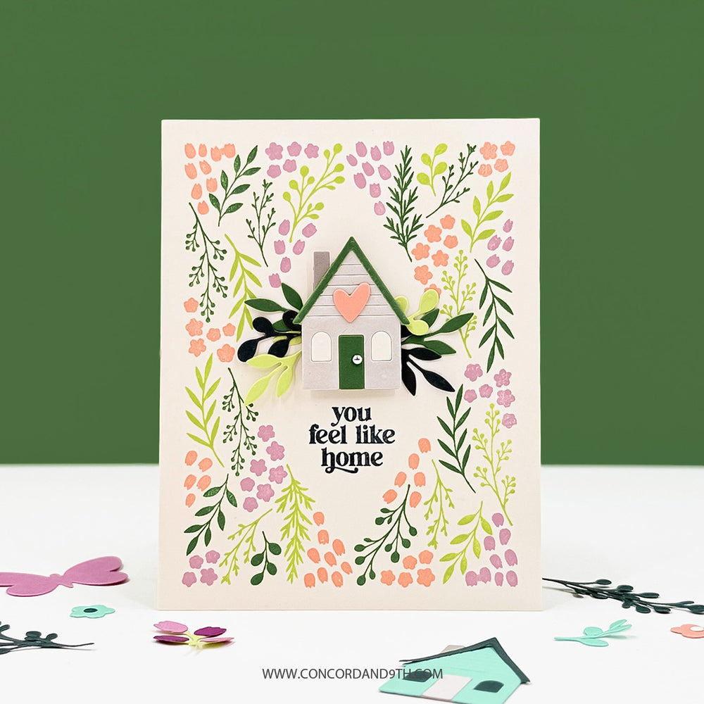A card made with the Concord & 9th Bloom & Grow set: a little house with a heart among pink and green floral sprigs, with 'you feel like home'.