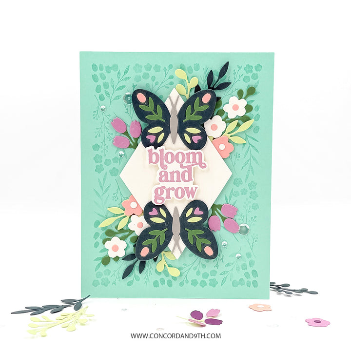 A card made with the Concord & 9th Bloom & Grow set: two navy butterflies with pink tulips and flowers and 'bloom and grow' on mint.