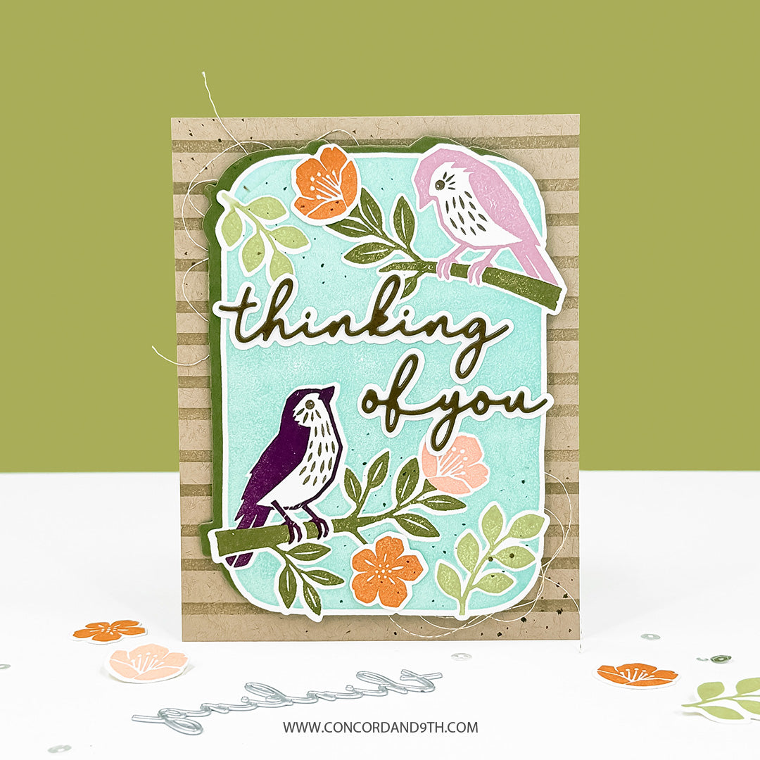 A card made with the Concord & 9th Finch Friends set: pink and purple birds on flowering branches with 'thinking of you' on kraft stripes.