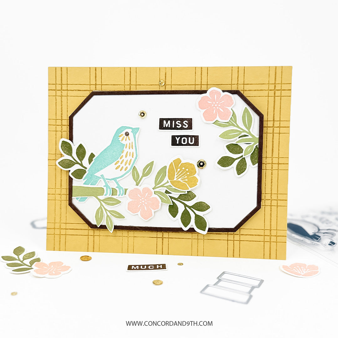 A card made with the Concord & 9th Finch Friends set: a blue bird on a flowering branch with 'miss you' on a yellow plaid background.
