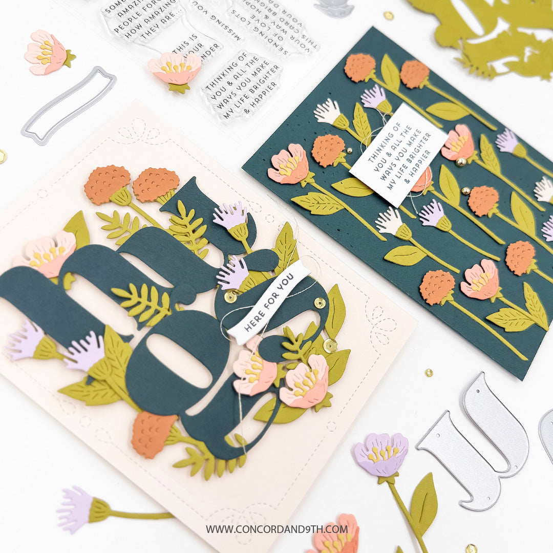 Close-up of two cards made with the Concord & 9th Floral Embrace set: a floral 'hugs' card and a dark teal card with tall coral and lilac flowers.