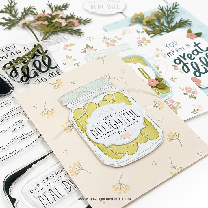 Card with a dill pickle design and text on a white surface with additional cards and decorative elements.