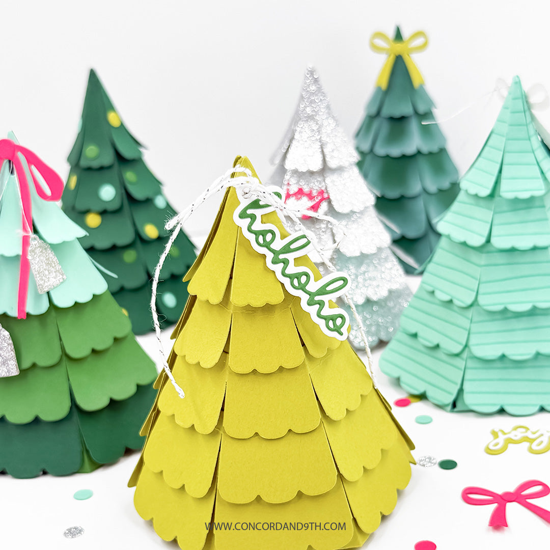 Concord & 9th Evergreen Box Dies — a row of finished gift boxes in dark green, mint, silver glitter and yellow cardstock with bow and tag toppers.
