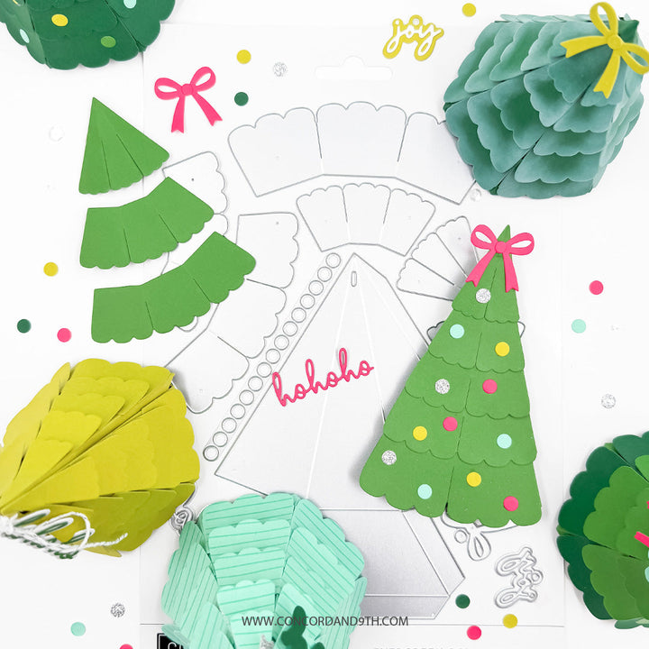 Concord & 9th Evergreen Box Dies — a close-up of three gift boxes, dark green with dot ornaments, mint striped, and pink-bowed mint, standing together.