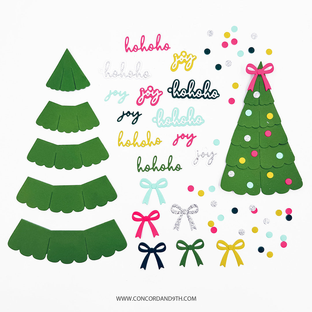 Concord & 9th Evergreen Box Dies — the scalloped tiers used to build the box shape, alongside loose bow and "hohoho"/"joy" tag die-cuts and a fully assembled ornament box.