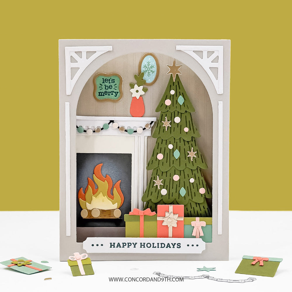 Concord & 9th Holiday Home Stamp Set — a dimensional shadow-box card with an arched mantel scene: fireplace, decorated tree, gifts and wall art, with a "Happy Holidays" sentiment strip.