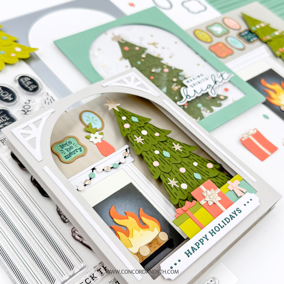 Concord & 9th Holiday Home Dies — two finished cards, the fireplace shadow-box scene and the shaker-dome tree card, shown together with sticker sheets and extra die-cuts.