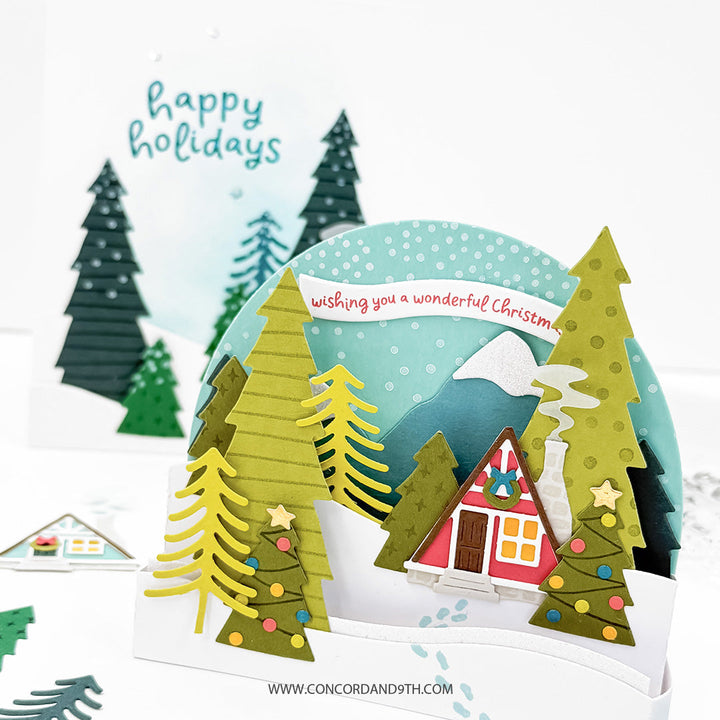 Concord & 9th Into the Woods Dies — two finished cards, the dimensional cabin scene and the flat cabin-in-the-snow card, shown together.