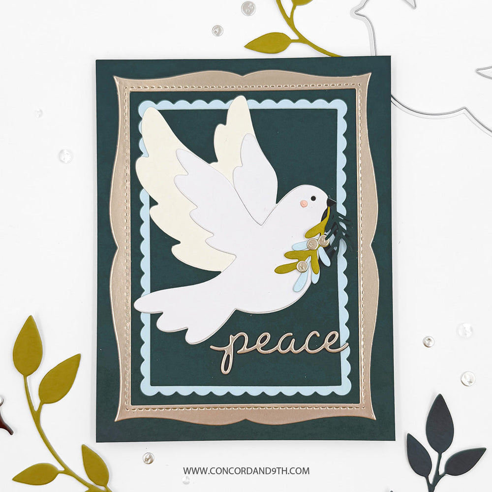 Concord & 9th Peaceful Dove Bundle — a dove die cut carrying a sprig in its beak on a dark teal card in a scalloped metallic frame, with a "peace" script sentiment.