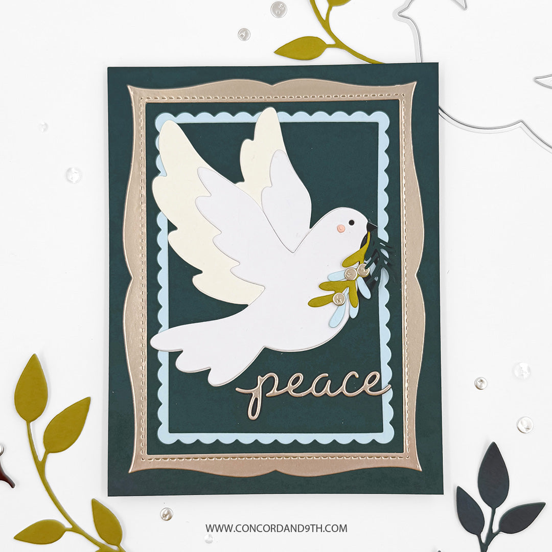 Concord & 9th Peaceful Dove Dies — a dove die cut carrying a sprig in its beak on a dark teal card in a scalloped metallic frame, with a "peace" script sentiment.