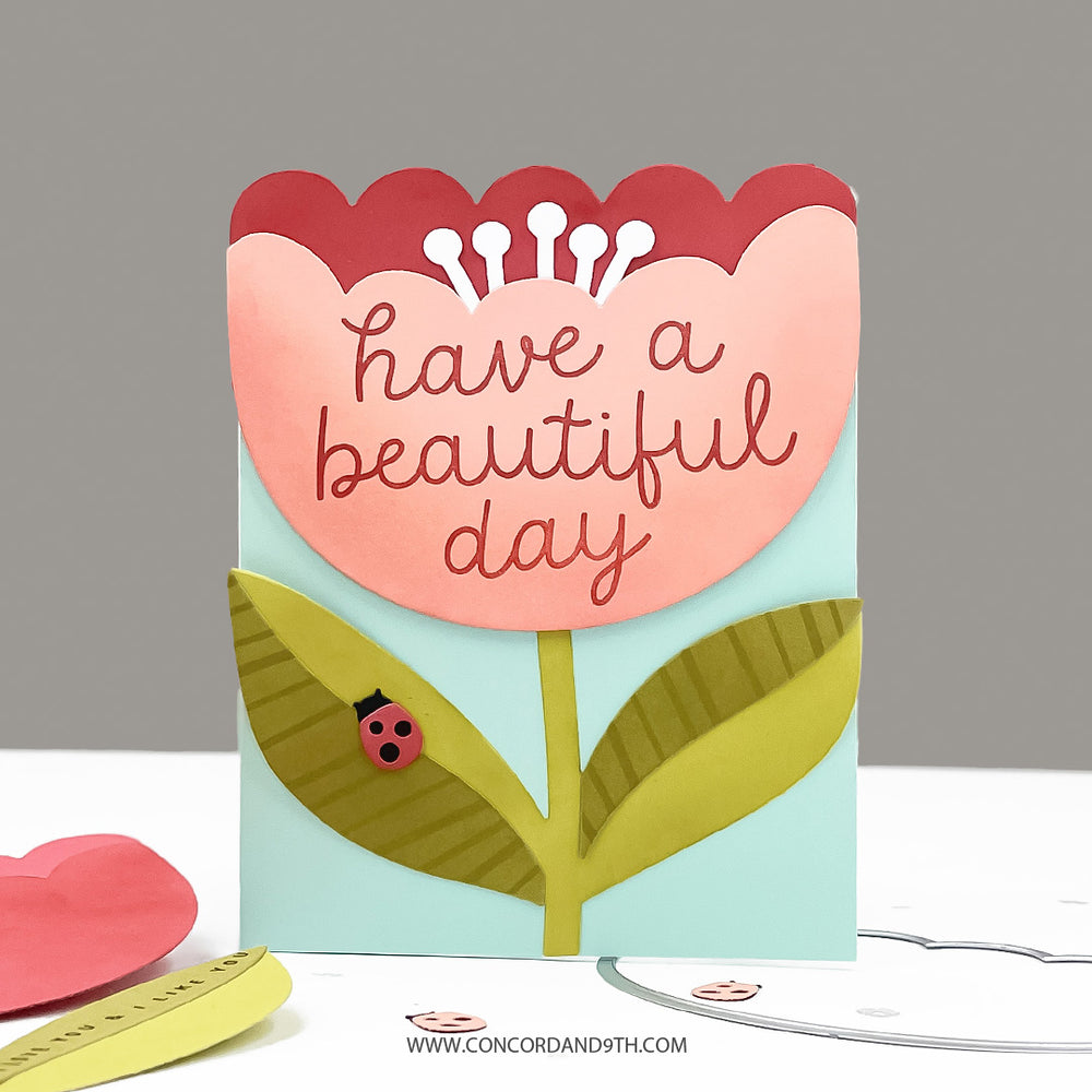 Card with floral design and 'have a beautiful day' text on a gray background
