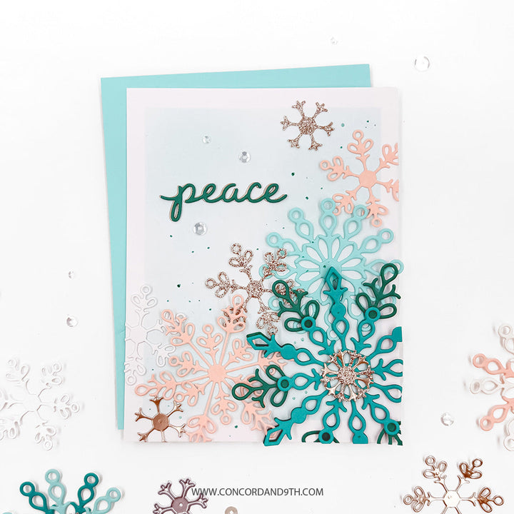 Concord & 9th Snowflake Season Dies — scattered die-cut snowflakes in teal, peach and gold cascading down the card, with a "peace" sentiment.
