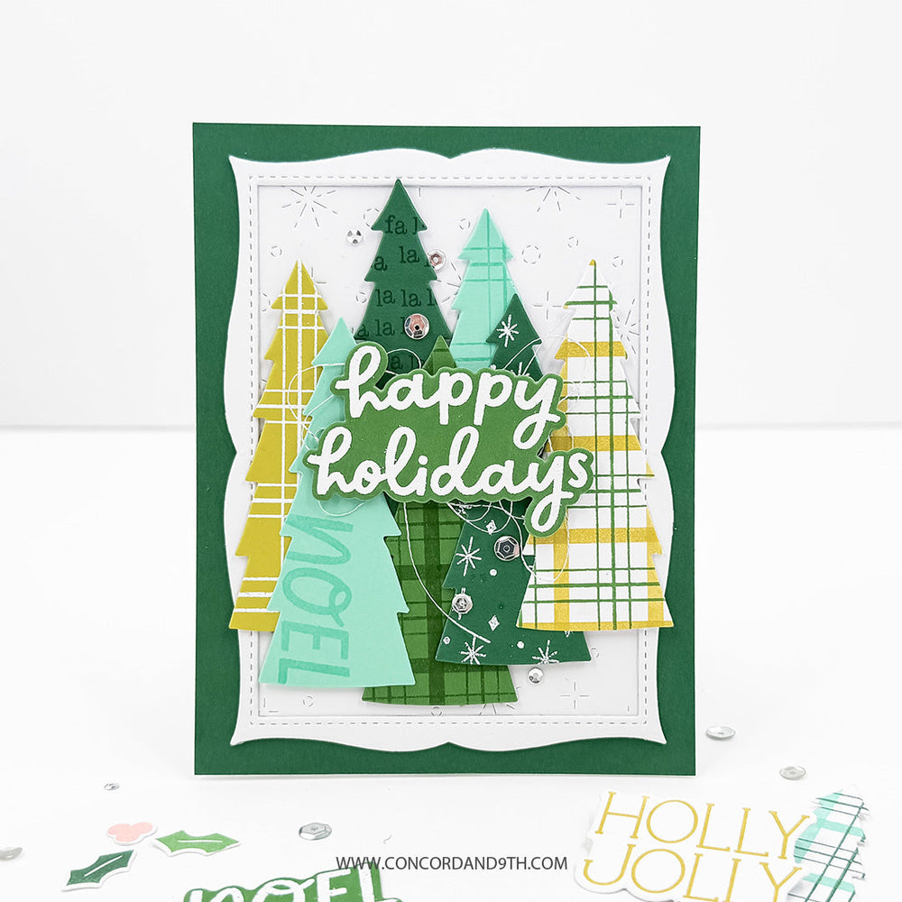 Concord & 9th Tidings of Joy Dies — a card layered with patterned Christmas tree die-cuts, a "NOEL" stamped tree, and a "happy holidays" sentiment.