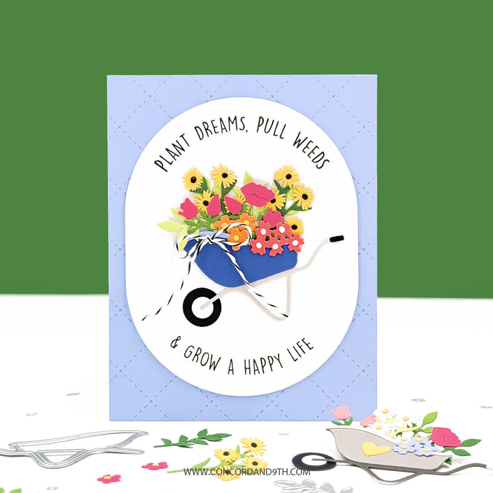 Card with a wheelbarrow full of flowers and text on a blue background