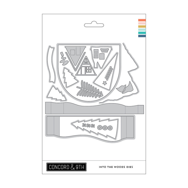 Concord & 9th Into the Woods Dies — an A-frame cabin die cut with a door and windows, plus triangle trees and a mountain border.