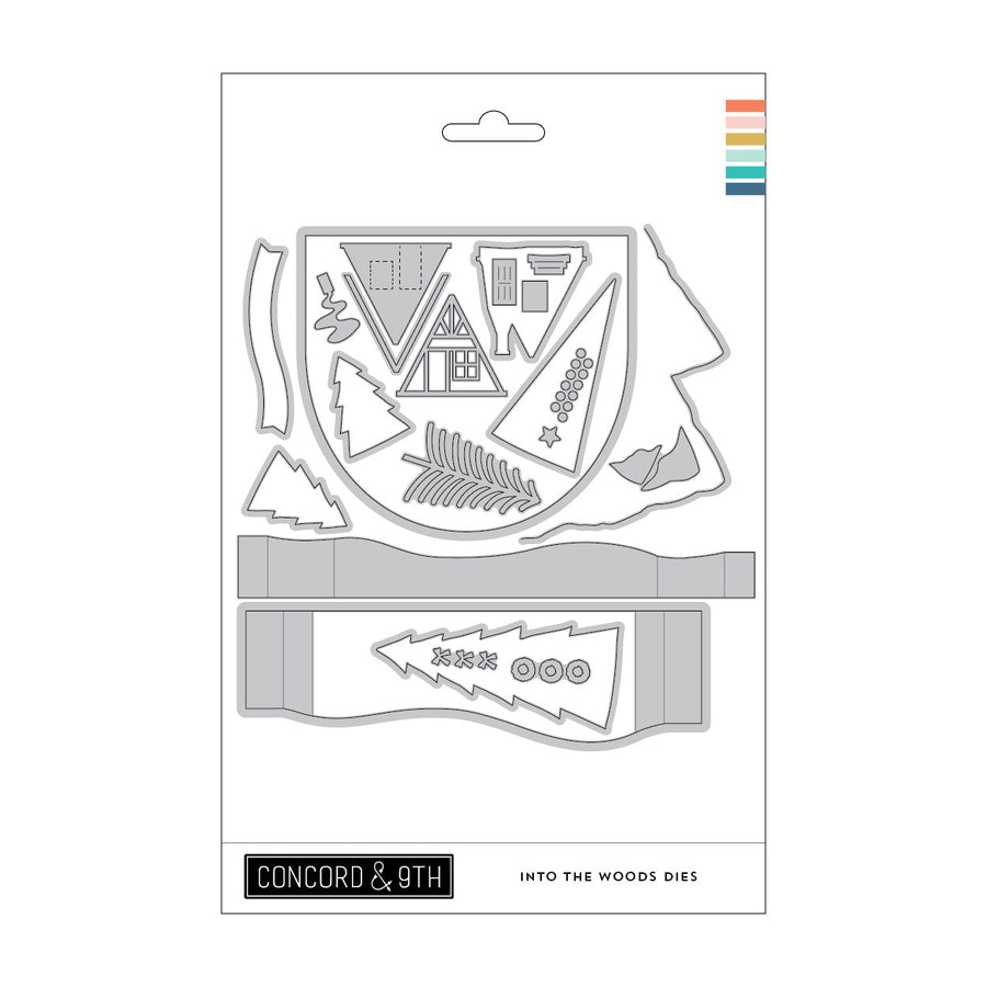 Concord & 9th Into the Woods Dies — an A-frame cabin die cut with a door and windows, plus triangle trees and a mountain border.