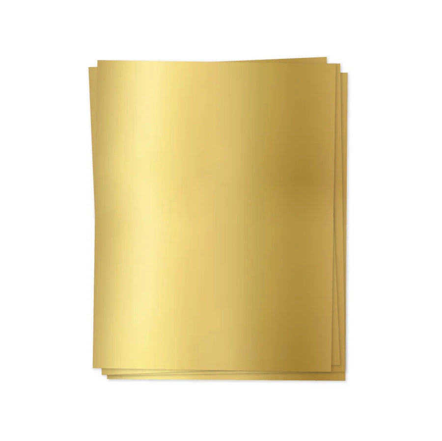 Stack of gold sheets on a white background