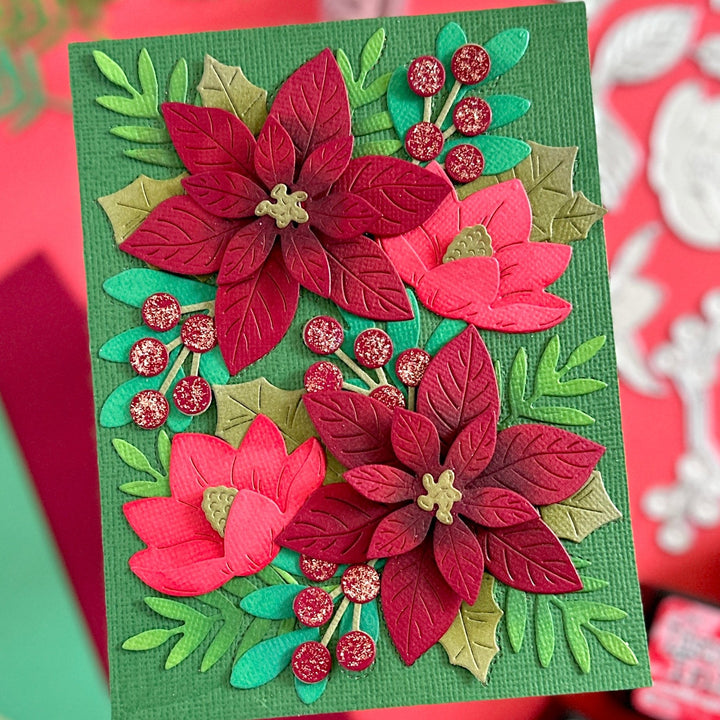 Festive blooms die set card created with traditional Christmas colours distress ink added for shadow dimension and stickler diamonds on the berries.