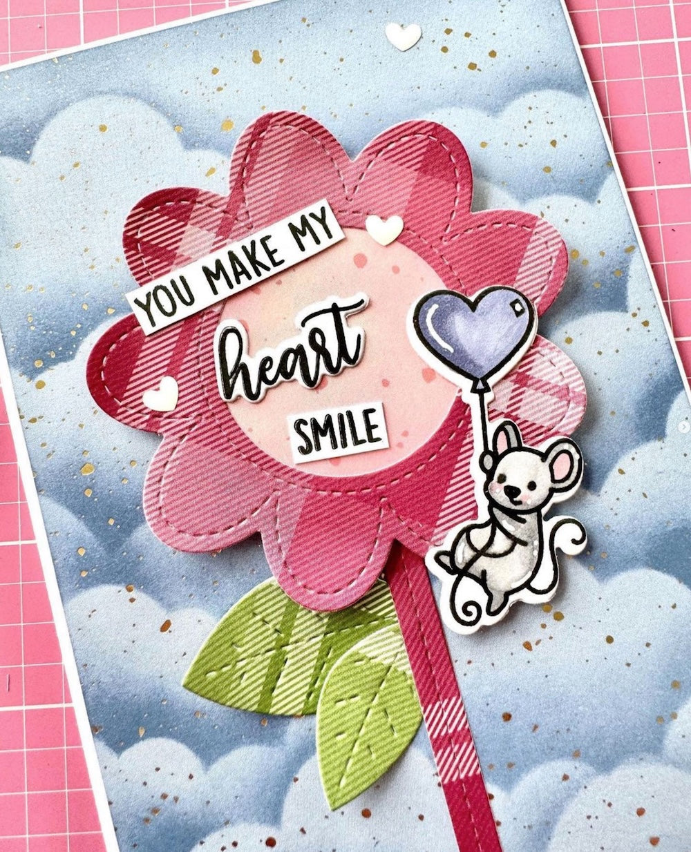 Card with pink flower design, heart, and dog illustration on a blue background