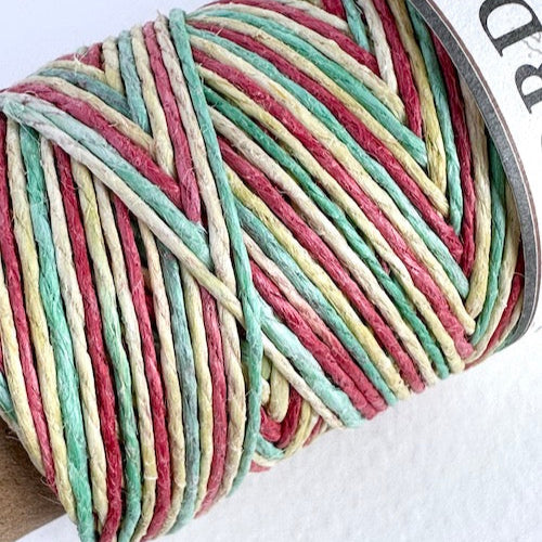 Spool of multicolored yarn on a white background