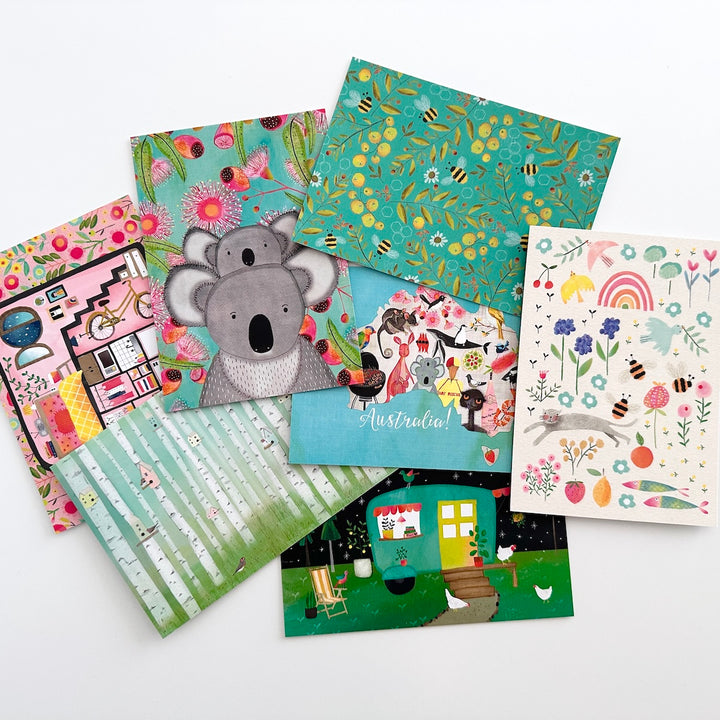 Collection of colourful Australian postcards with various designs on a white background
