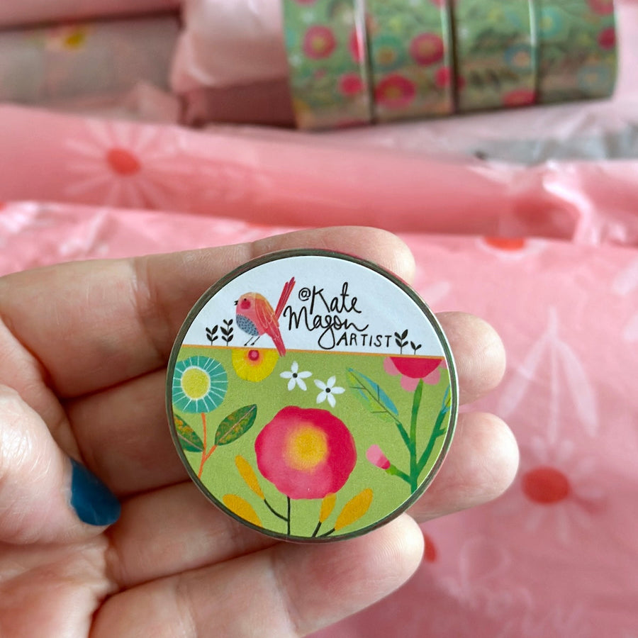 Kate Mason washi tape held in hand with a pink background