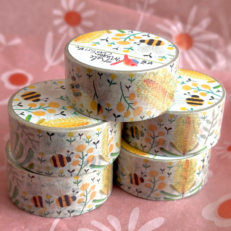 five rolls of decorative tape with floral and bee pattern on a pink floral background