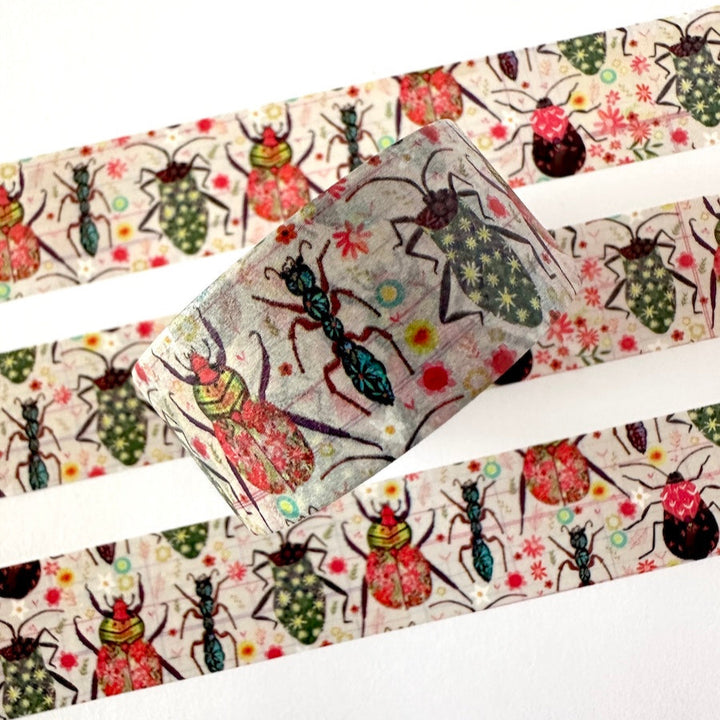 Decorative washi tape with colorful insect designs on a white background