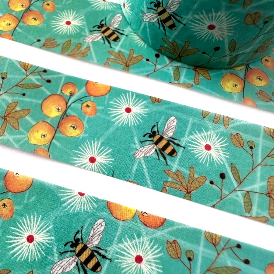 Washi tape with bee and floral design on a turquoise background