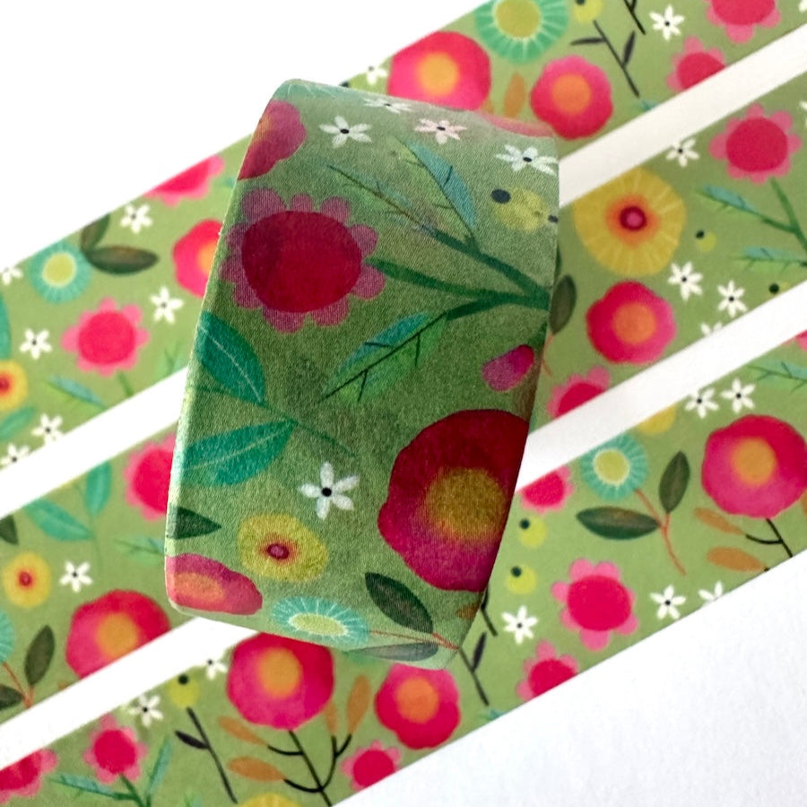 Floral patterned washi tape with pink and red flowers on a green background