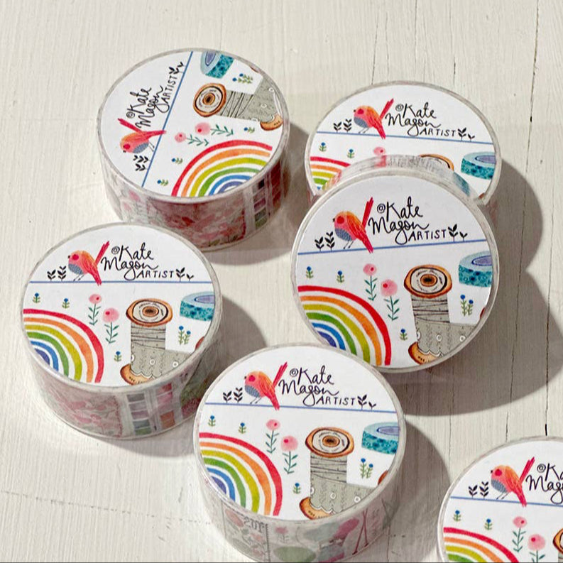 Set of six rolls of decorative tape with colorful designs on a light wooden surface.