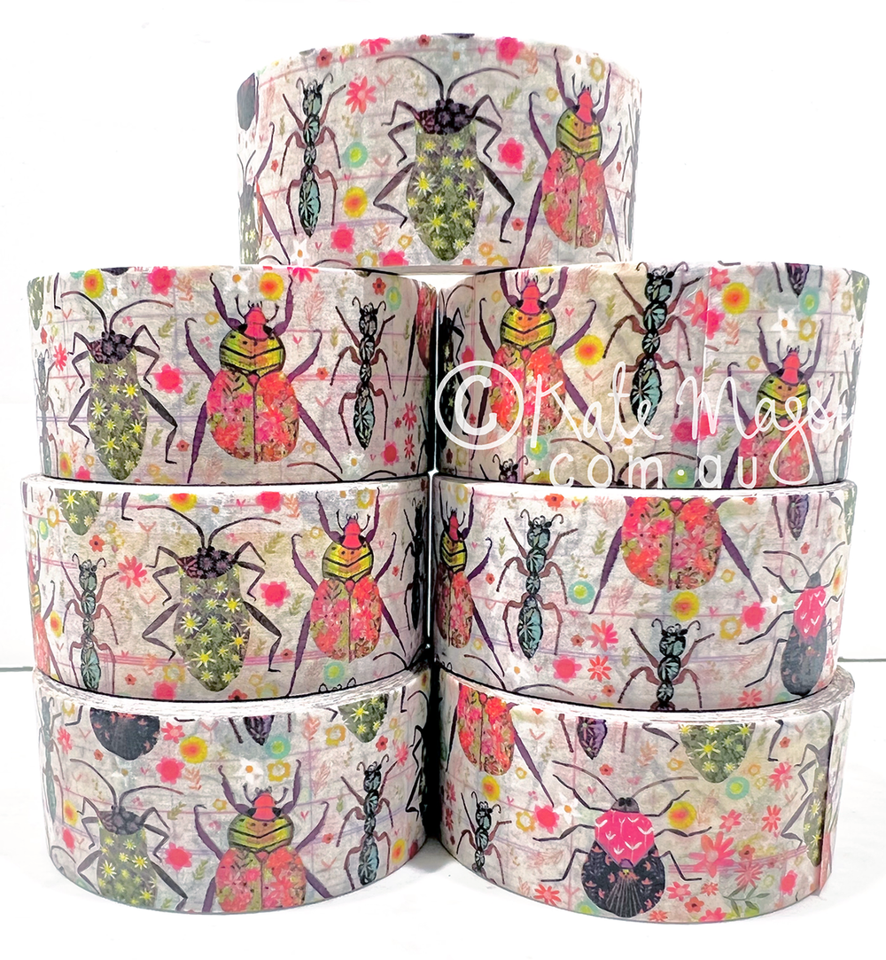 Stack of washi tapes designed by Kate Mason Art with beetle and floral pattern on a white background