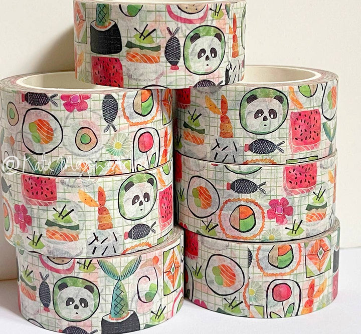 Set of colorful washi tape rolls with panda and sushi designs on a white background