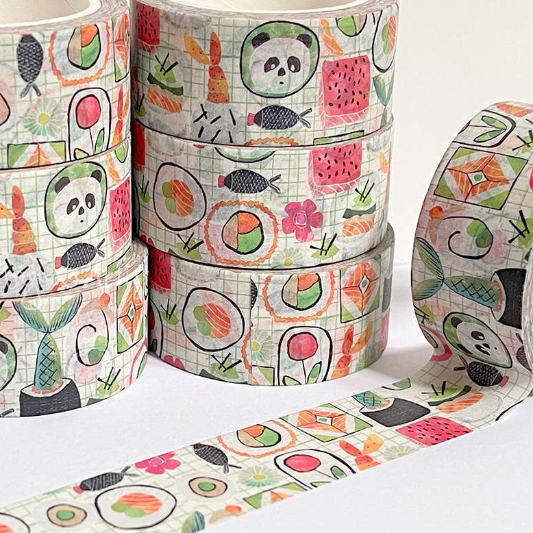 Rolls of decorative tape with panda and sushi designs on a white background