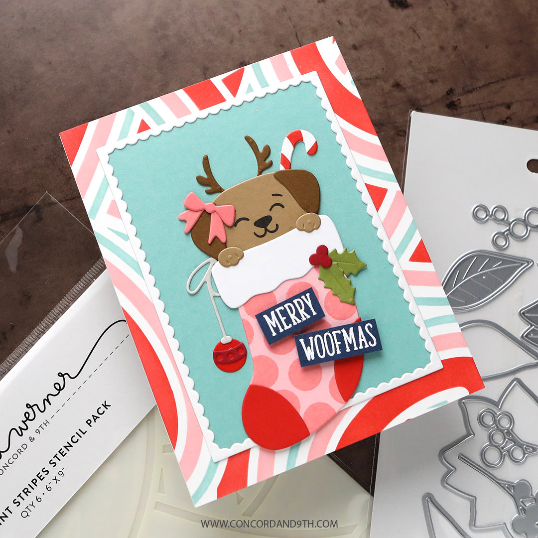 A card made with Kristina Werner's Happy Pawlidays Dies: a puppy with reindeer antlers in a pink polka dot stocking with 'Merry Woofmas' on peppermint stripes.
