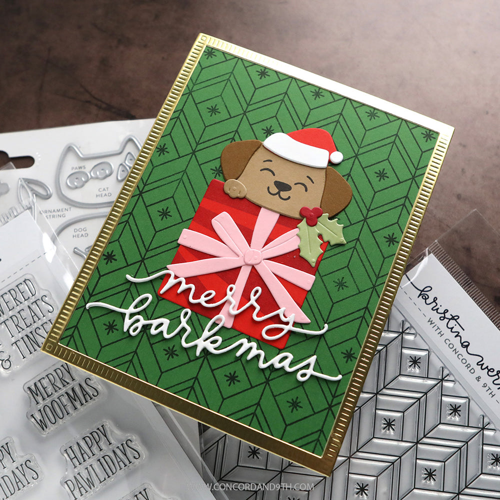 A card made with Kristina Werner's Happy Pawlidays Stamp Set: a puppy in a Santa hat peeks out of a red gift above 'merry barkmas' in white script.