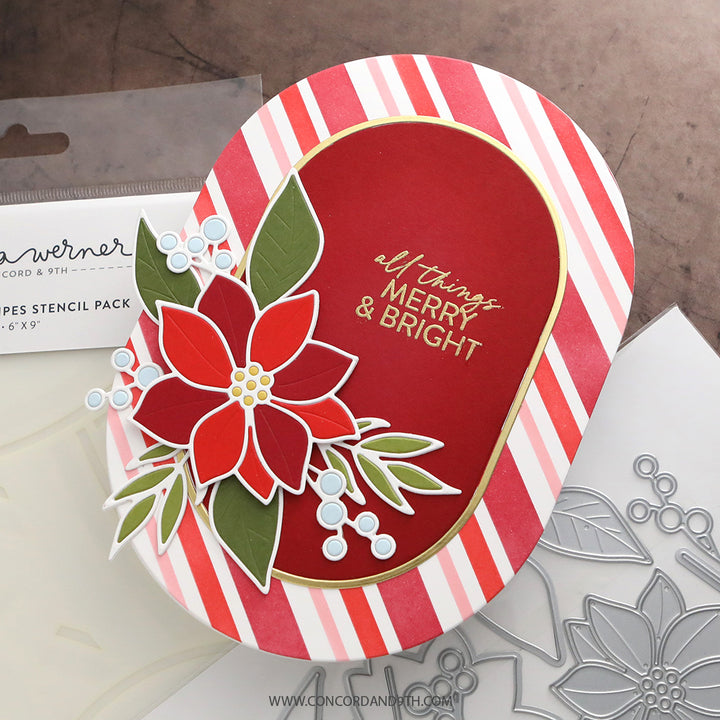 A card made with Kristina Werner's Poinsettia Inlay Dies: a poinsettia cluster and 'all things merry & bright' on a red oval over red and pink stripes.