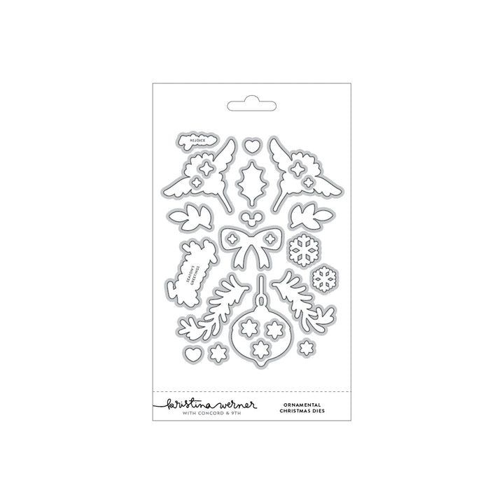 Concord & 9th Kristina Werner Ornamental Christmas Dies — angel wing, holly, bow, ornament, and snowflake dies with "Rejoice" and "Season's Greetings" word dies.
