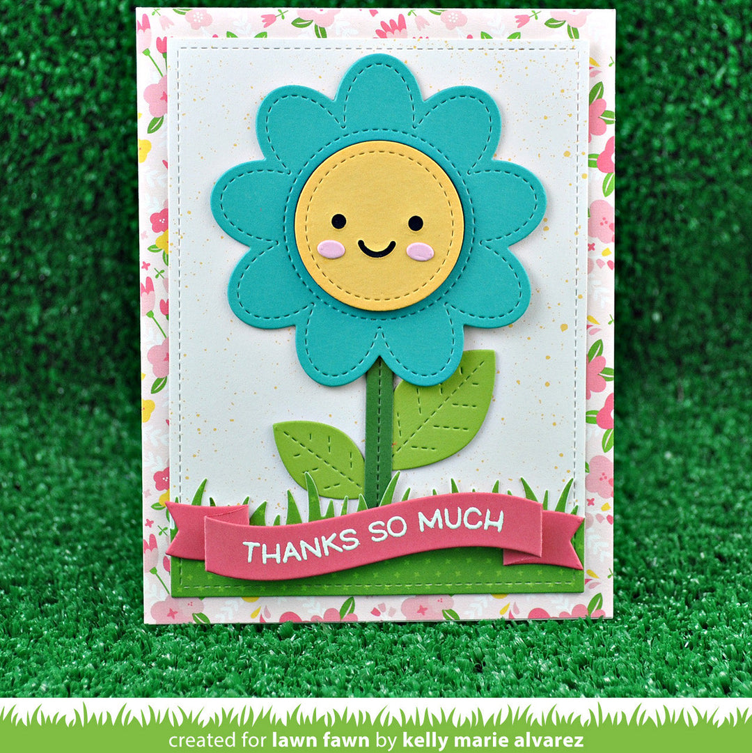 Card with a smiling flower design and 'Thanks so much' banner on a grassy background