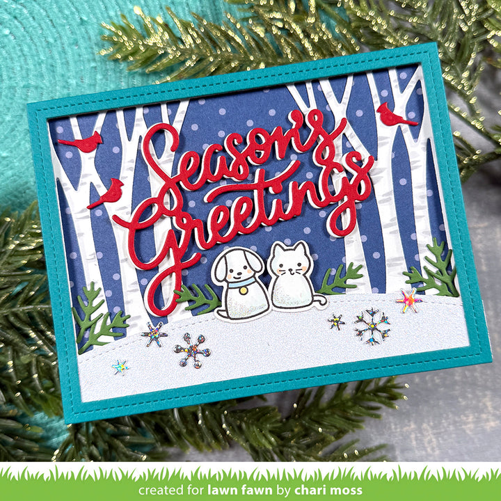 Lawn Fawn Giant Season's Greetings card with red script over a snowy birch forest and dogs, by Chari Moss