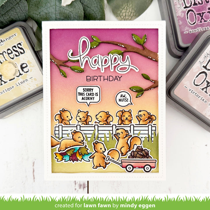 Birthday card with cartoon squirrels and 'Happy Birthday' text, surrounded by stamping supplies.