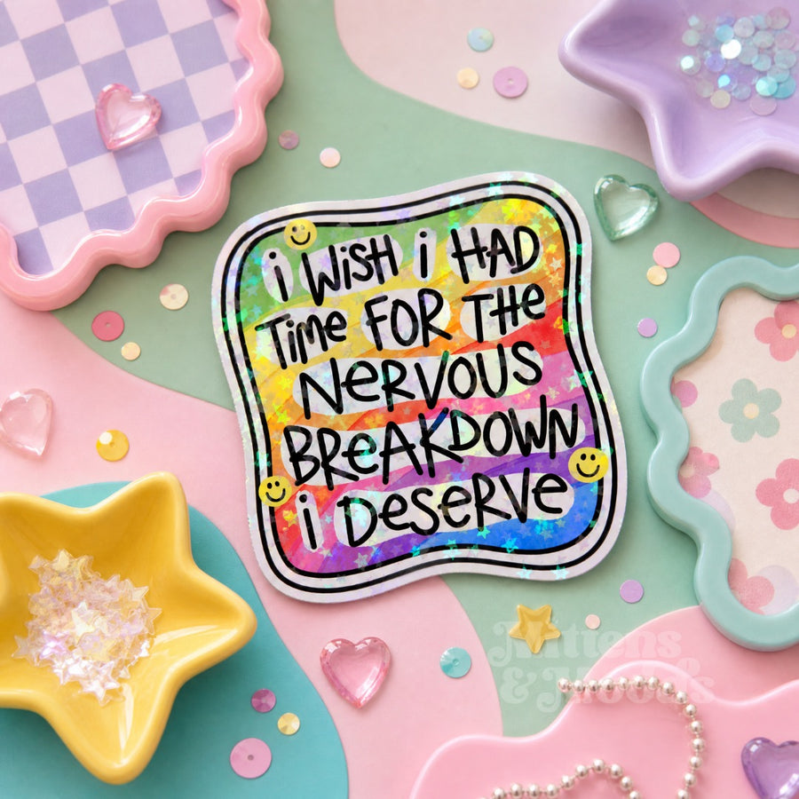 A square sticker with a colorful rainbow background and black text reading 'i WISH I HAD TIME FOR THE NERVOUS BREAKDOWN I DESERVE' with small yellow smiley faces, shown on a pastel pink and mint background with decorative pastel objects.