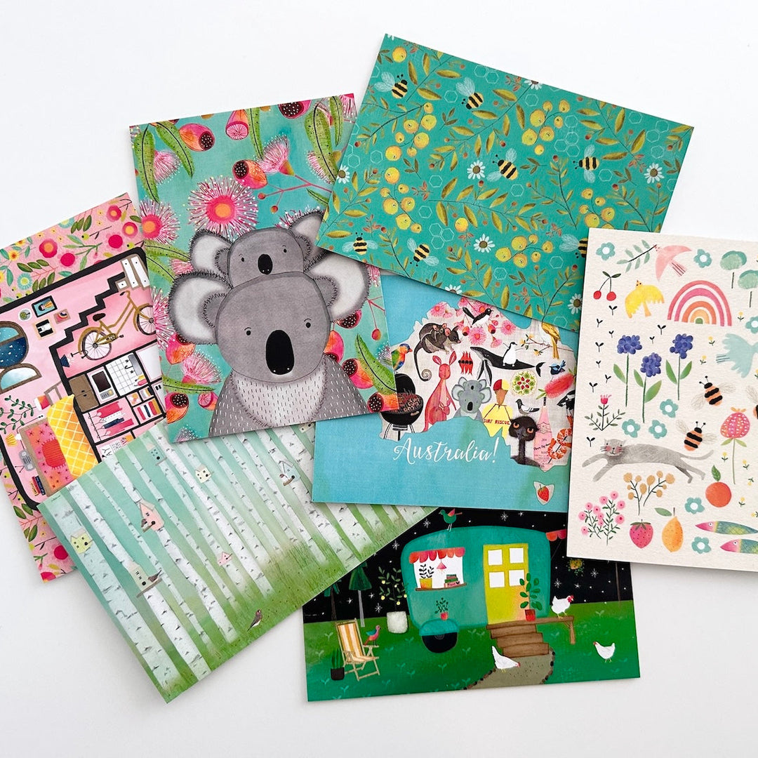 Collection of colourful postcards with various designs on a white background