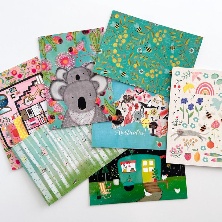 Collection of colourful postcards with various designs on a white background