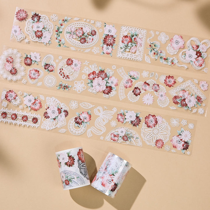 Three lengths of decorative washi tape with an elegant floral and lace pattern, displayed on a beige background with soft shadows.
